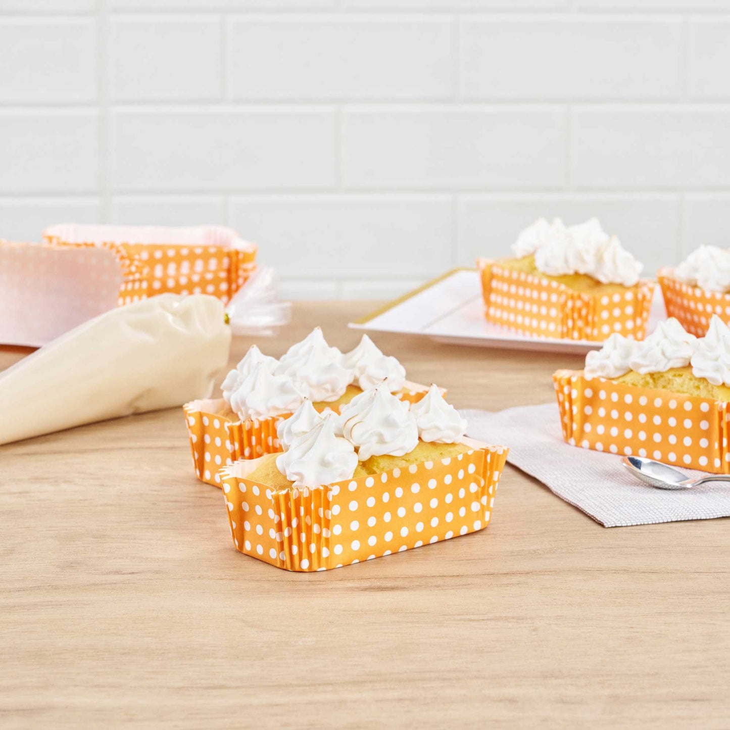 Panificio 5 oz Elliptical Polka-Dotted Hot Orange Paper Large Baking Cup - Ridged - 4 1/2" x 2 1/2" x 1 1/4" - 200 count box