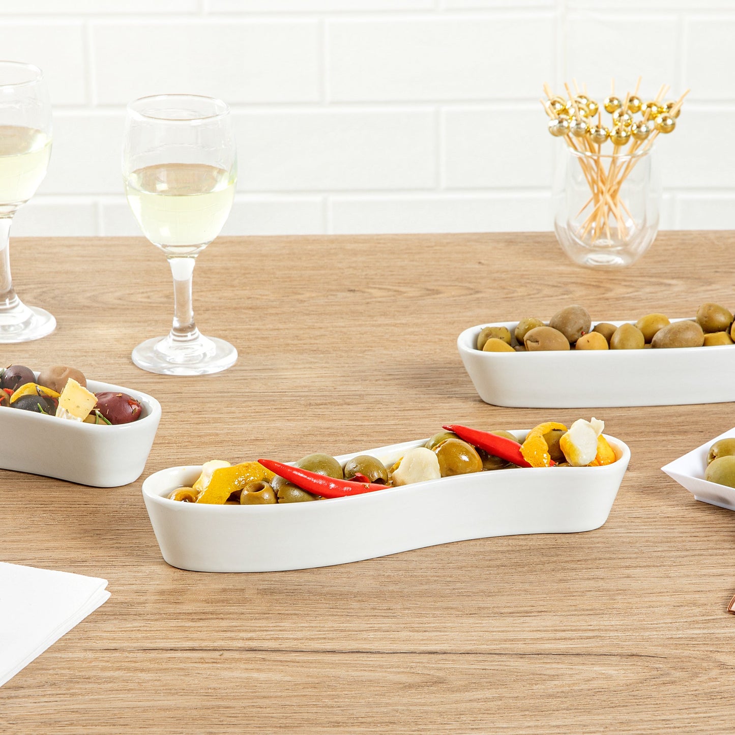 Chef 101 Swerve 6 oz Curved White Porcelain Olive Plate - 8 3/4" x 2 1/4" x 1 1/2" - 1 count box