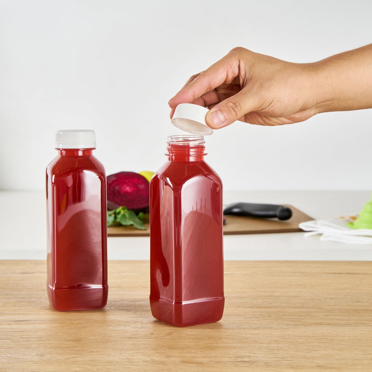 Bottle Tek 16 oz Square Clear Plastic Cold Pressed Juice Bottle - with Safety Cap - 2 1/4" x 2 1/4" x 7" - 100 count box
